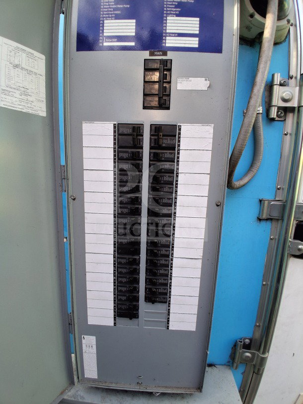 Electrical panel inside a 2021 Diamond Cargo 24' Custom Mobile Kitchen, showing labeled breakers and wiring setup.