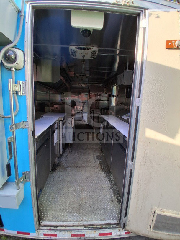 2021 Diamond Cargo 24' custom mobile kitchen interior with stainless steel, double fryers, and refrigeration. LOT-107.
