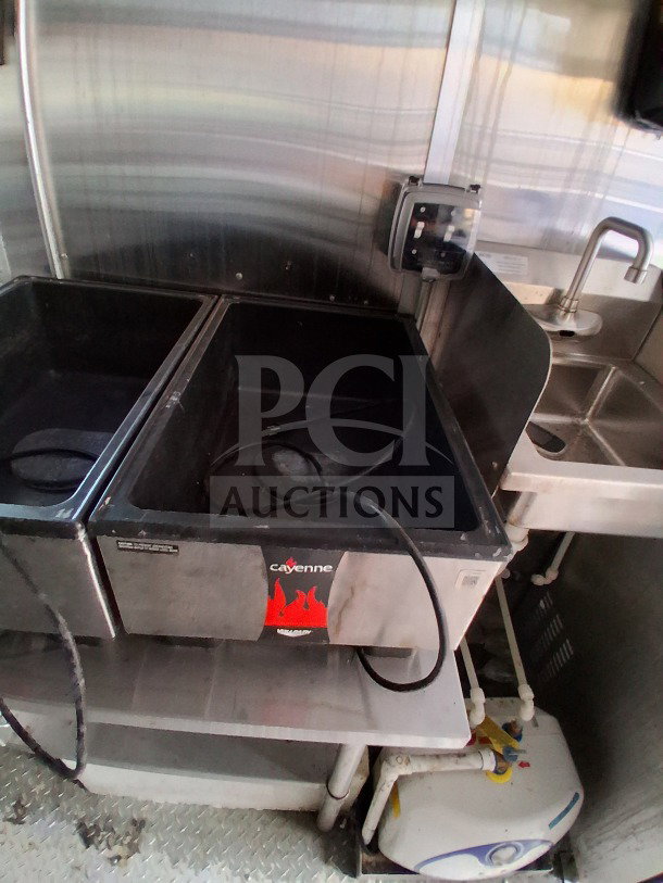2021 Diamond Cargo 24' Custom Mobile Kitchen interior, featuring stainless steel surfaces and utility sink. Pyro-Chem fire system.