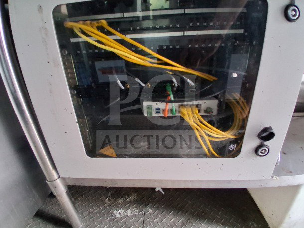 Interior view of a 2021 Diamond Cargo 24' Custom Mobile Kitchen, featuring networking equipment and visible cables.