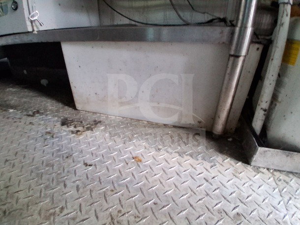 Diamond-plate flooring of 2021 Diamond Cargo 24' Custom Mobile Kitchen, highlighting durable industrial design.