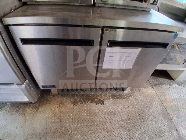 2021 Diamond Cargo 24' mobile kitchen featuring Arctic Air fridge, stainless steel interior, with visible labels for inventory.