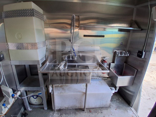 2021 Diamond Cargo 24' mobile kitchen interior featuring stainless steel sink setup, water tank, and fire extinguisher.