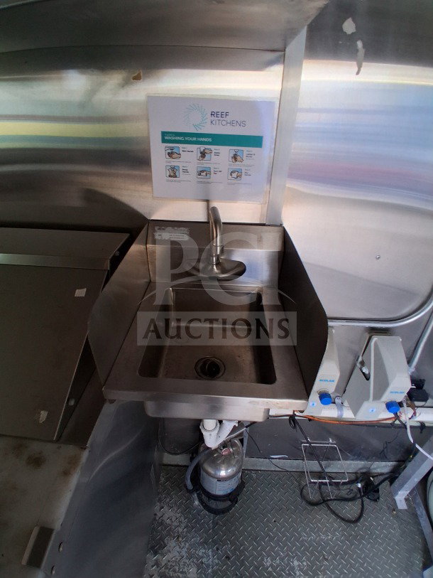 2021 Diamond Cargo 24' Custom Mobile Kitchen sink area with stainless steel interior and handwashing guide.