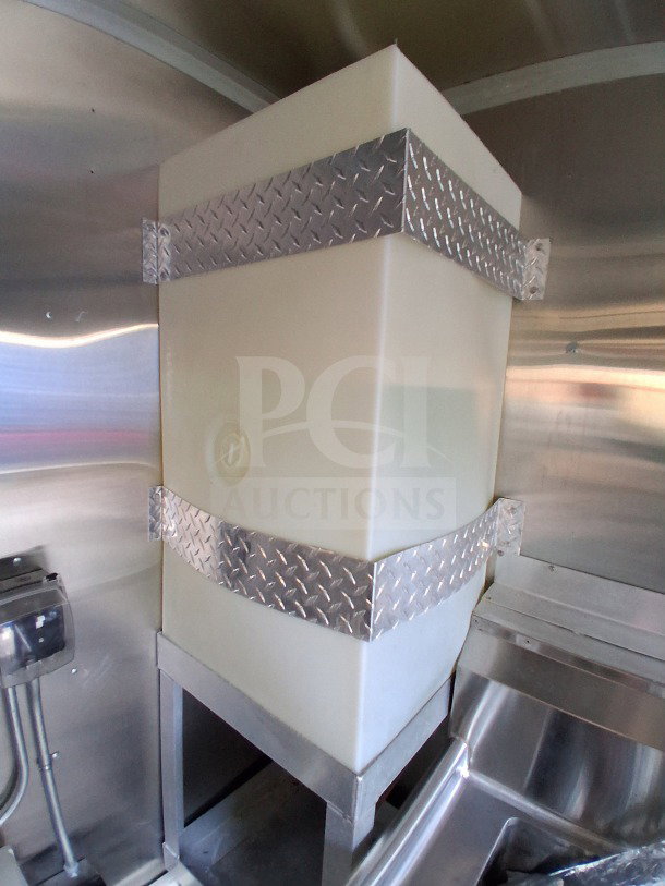 2021 Diamond Cargo 24' Custom Mobile Kitchen interior, showing a large white tank with metal straps, stainless steel walls.