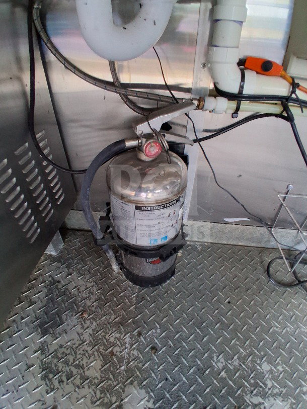 Pyro-Chem fire suppression system installed in a Diamond Cargo 24' mobile kitchen, featuring stainless steel interior.