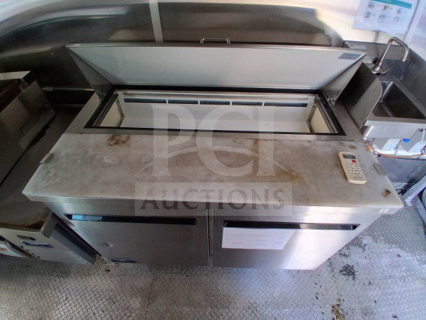 2021 Diamond Cargo 24' Mobile Kitchen, featuring stainless steel interior and Arctic Air refrigeration, showing slight wear.