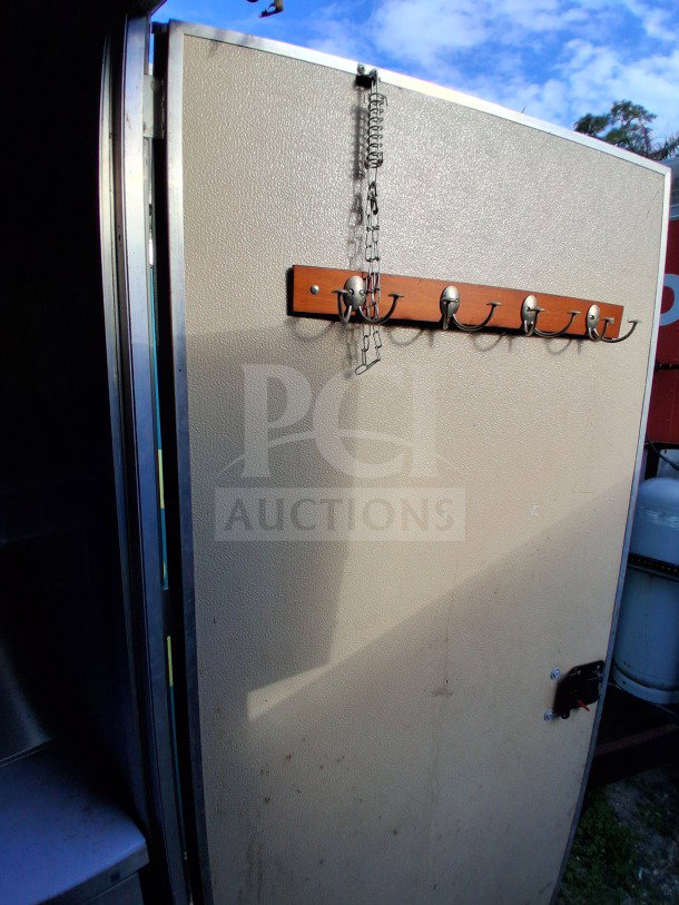 2021 Diamond Cargo 24' Custom Mobile Kitchen exterior door with interior metal surface and wall-mounted hook rack.