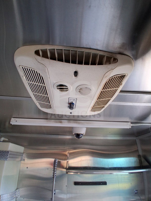 Interior view of 2021 Diamond Cargo 24' Mobile Kitchen with stainless steel setup and overhead ventilation system.