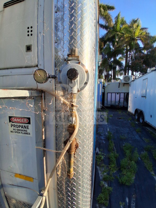 2019 Quality Cargo Food Trailer, propane connection, visible "Danger Propane" sign, diamond-plate exterior.