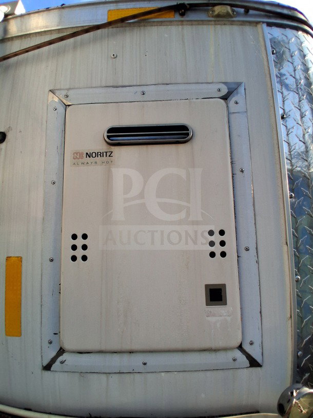 2019 Quality Cargo Food Trailer exterior with Noritz vent. Commercial kitchen features include grease hood, fryers, griddle.
