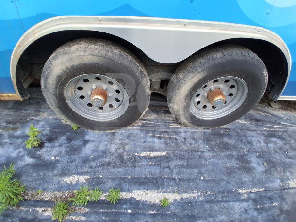 2019 Quality Cargo Food Trailer wheels, showing dual axles and sturdy tires on a commercial kitchen trailer.