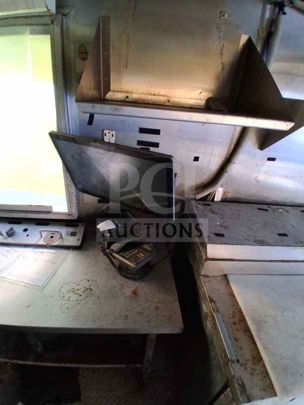 2019 Quality Cargo commercial kitchen trailer interior showing used counter space, order window, and shelving.