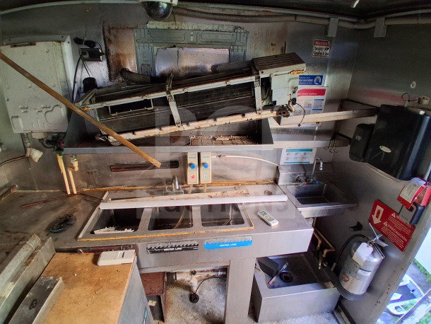 2019 Quality Cargo Food Trailer with grease hood, dual fryers, griddle, burner cooktop, Atosa refrigeration, and large order window.