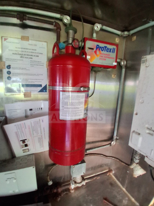 2019 Quality Cargo food trailer interior with ProTex II fire suppression system and safety notices.