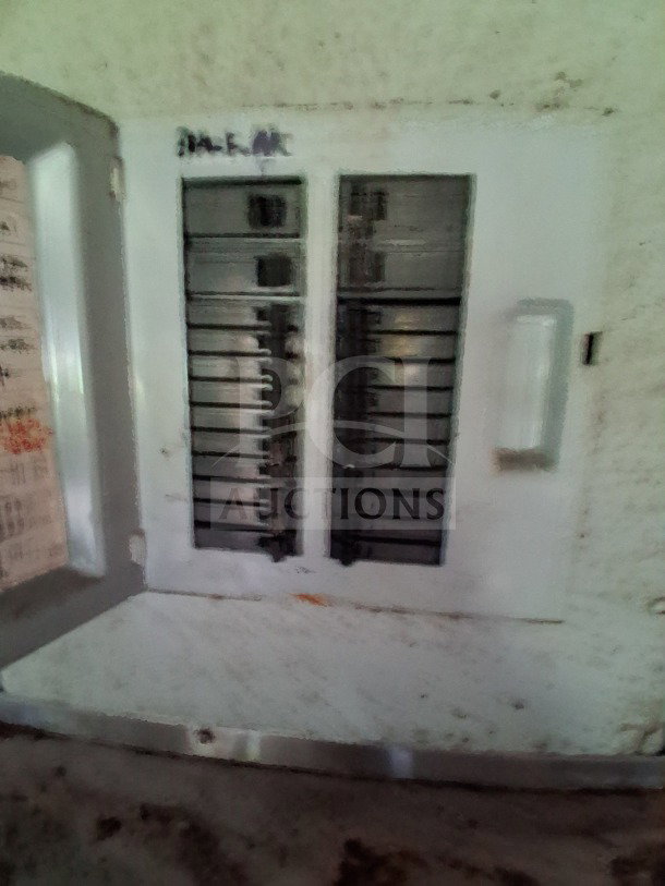 Electrical panel inside 2019 Quality Cargo food trailer. Panel has multiple breakers labeled with faded writing.