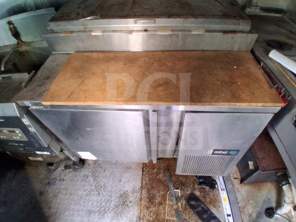 2019 Quality Cargo Food Trailer interior with Atosa refrigeration suite, grease hood, and cooking equipment; used condition.