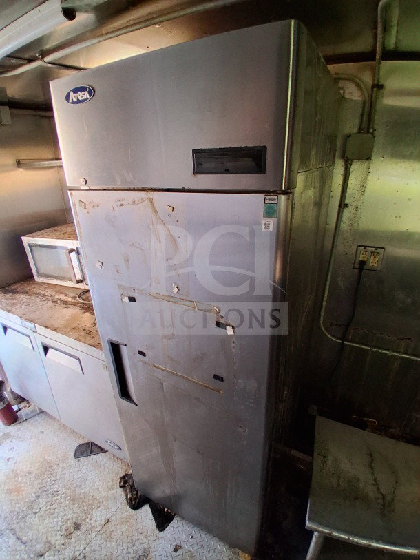 2019 Quality Cargo food trailer interior showing a large Atosa refrigerator in a commercial kitchen setup.