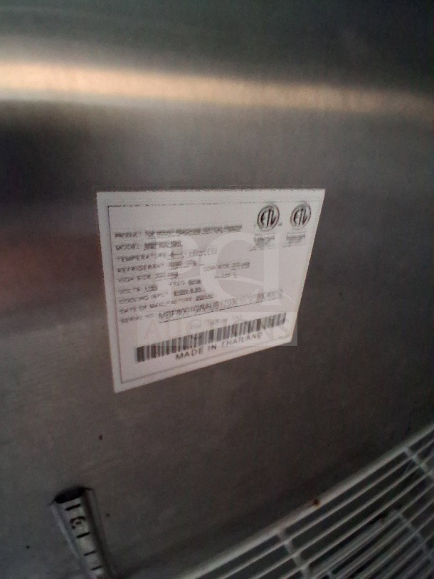 Label on Quality Cargo Food Trailer refrigeration unit, indicating model and specs, made in Thailand.