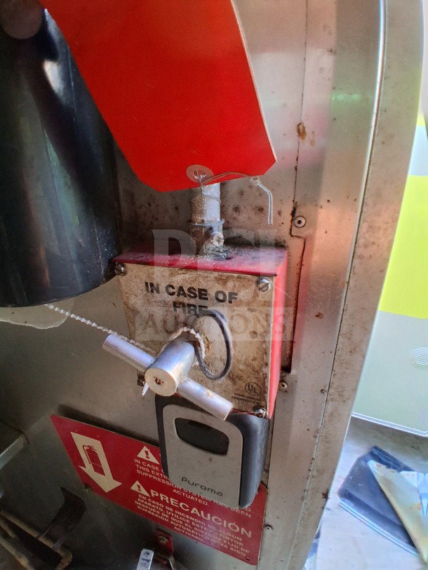 Fire suppression system control inside a 2019 Quality Cargo Food Trailer. Features "In Case of Fire" signage.