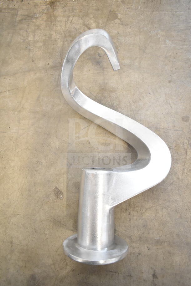 Silver dough hook attachment for Globe SP40 mixer, brand new condition, visible scratch and dent on a concrete backdrop.