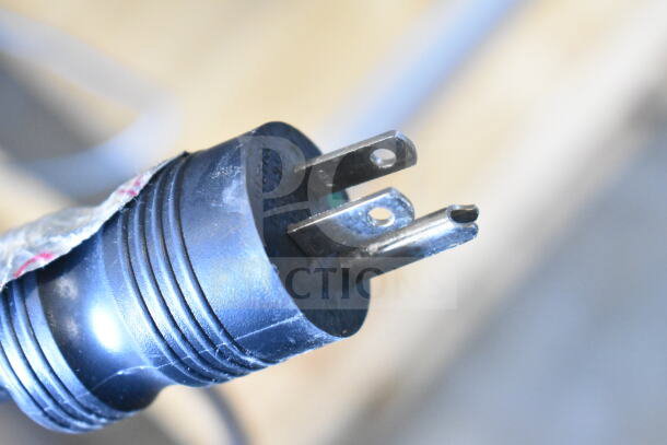 Close-up of a black, three-pronged power plug attached to the 2024 Blodgett Invoq Hybrid Combi Oven, model Hoodini 10-2/1GN.