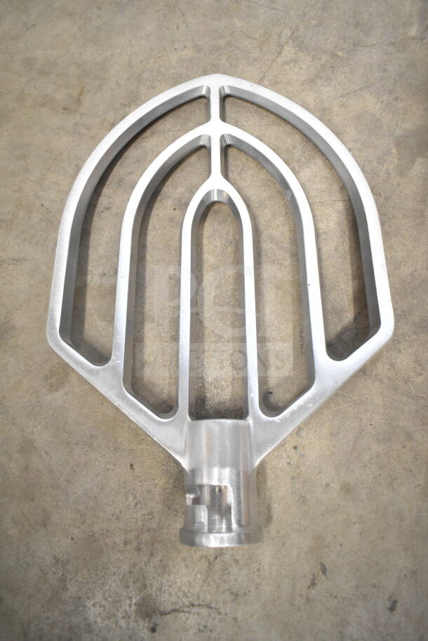 Aluminum paddle attachment for Globe SP40 mixer, new condition, resting on a concrete surface.