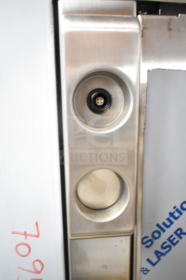 Close-up of Blodgett BLCT62EFS/CPE2.06 oven panel; stainless steel finish, showing dials and connectors. New, with minor scratches.