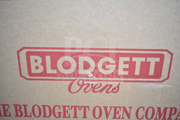 Brown cardboard box with red "Blodgett Ovens" logo. Contains new 2025 Blodgett 1415 commercial electric pizza oven, scratch and dent condition.
