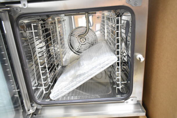 Brand new Blodgett BLCM23E/CSC2306 combi convection oven, electric, interior view with racks, minor scratches.