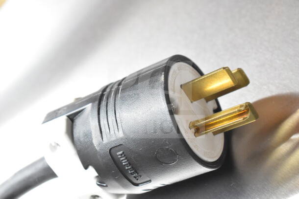 2024 Perfect Fry PFA730 ventless deep fryer power plug, 208 volts, scratch and dent. Close-up of prongs and casing.