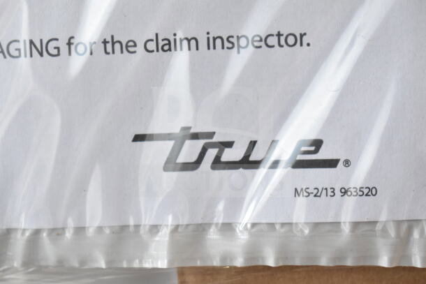 Alt Text: True logo on packaging for brand new True TSCI-600R-G-PH Commercial Cooler. Includes model and inspection instructions.