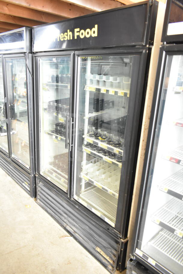 True GDM-49 commercial 2-door reach-in cooler merchandiser, black exterior, glass doors, 115 volts, 1 phase, used condition.