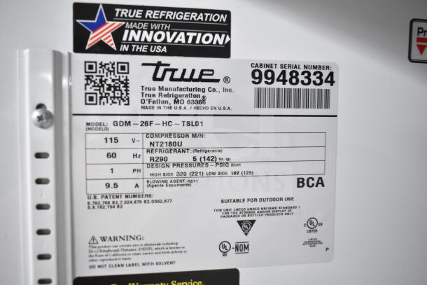 Label from a 2020 True GDM-26F-HC commercial cooler. Shows model info, refrigerant type R290, and voltage 115V. Serial number 9948334.