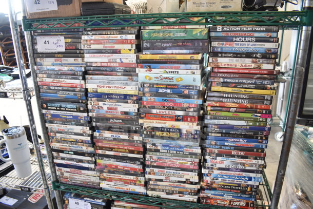 Collection of 340 DVDs, including titles like 8 Mile, The Simpsons, and Bad Teacher, stacked on shelves.
