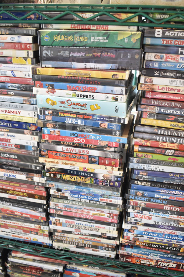 Collection of 340 DVDs stacked on shelves, featuring titles like 8 Mile, The Simpsons, and Bad Teacher. Various genres.