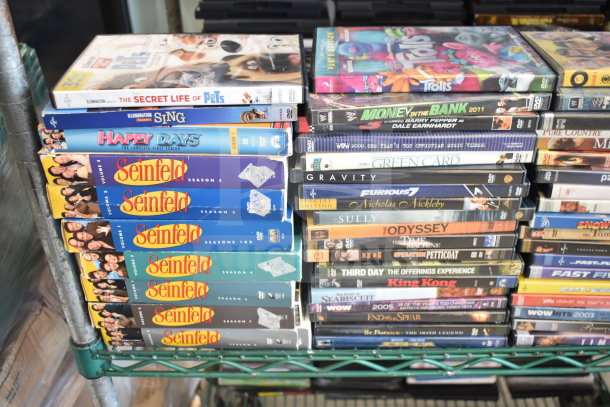 Collection of 340 DVDs, including titles like "8 Mile," "Seinfeld," and "The Secret Life of Pets," in good condition.