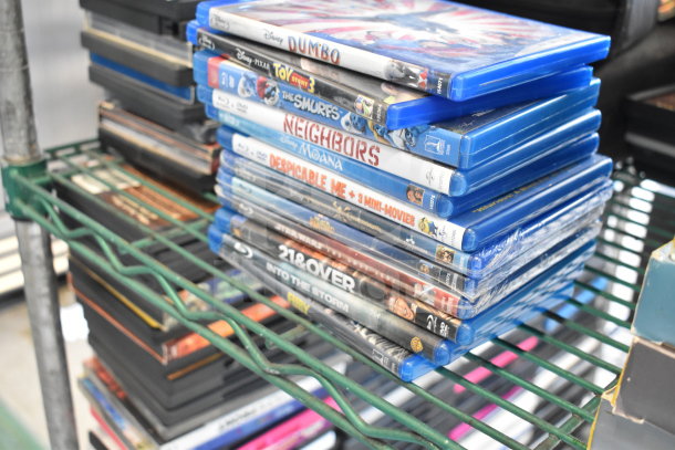 Stack of 340 various DVDs including "8 Mile," "Catch Me If You Can," and "The Simpsons," in assorted cases.