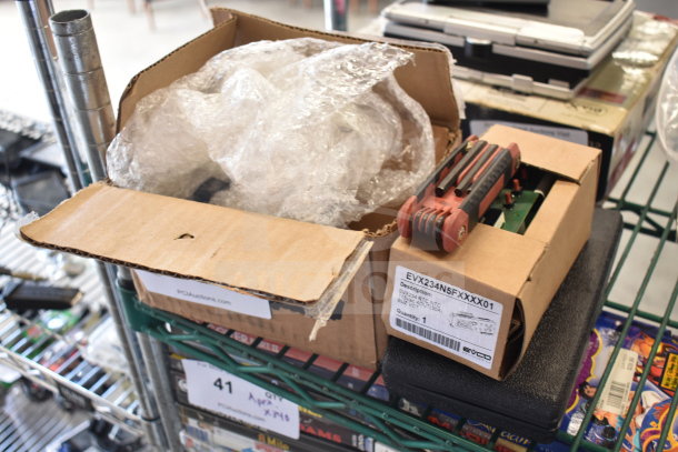 Four items including Fryclone Oil Pump 259POFM728L, EVX234N5FXXXX01 panel, and tool in a hard case. Boxes on shelf.