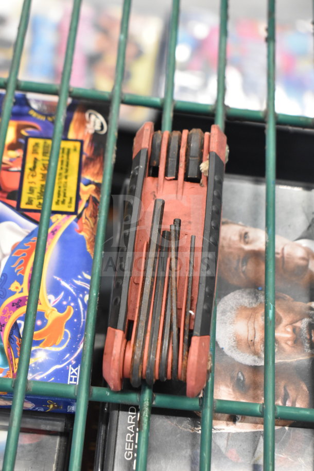 Red multi-tool on display, surrounded by various boxed items.