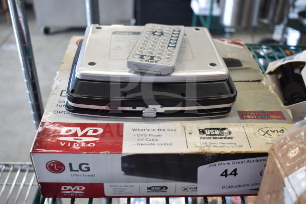 Two DVD players, including an LG with original box, and a Coby with remote, both in used condition.