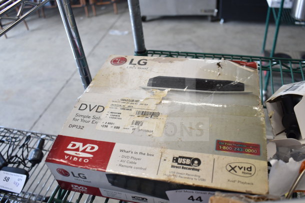 LG DVD Player (model DP132) box, visible wear, includes AV cable and remote; Coby DVD Player not pictured.