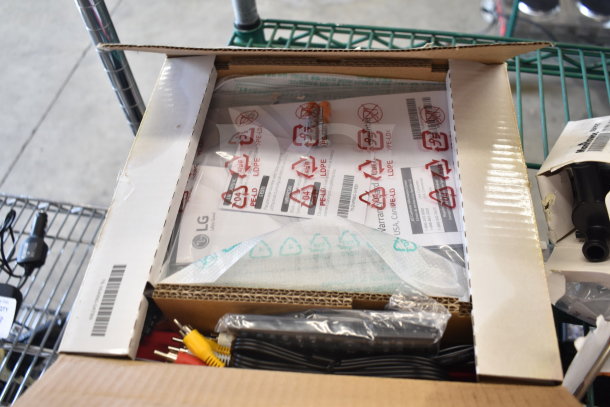 Box containing LG and Coby DVD players, with visible cables and LG warranty label. Item is part of a two-item auction lot.