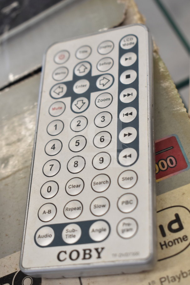 Remote control for Coby DVD Player with multiple function buttons, including play, zoom, and subtitle options.