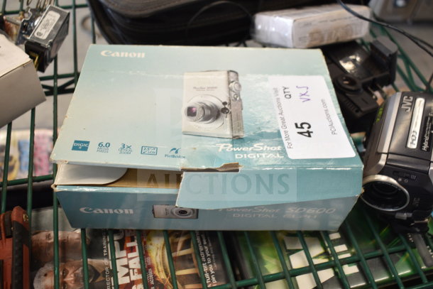 5-item lot including Canon PowerShot SD600 camera, 6MP, 3x zoom, JVC camcorder, in fair condition, original packaging.