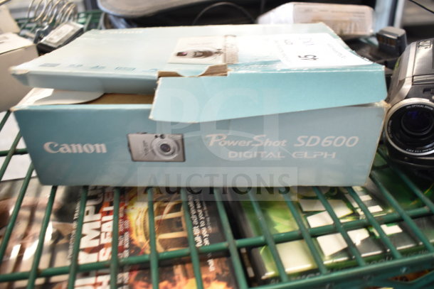 Canon PowerShot SD600 Digital ELPH box with camera; includes JVC recorder. Auction: 5 items. Box slightly worn.