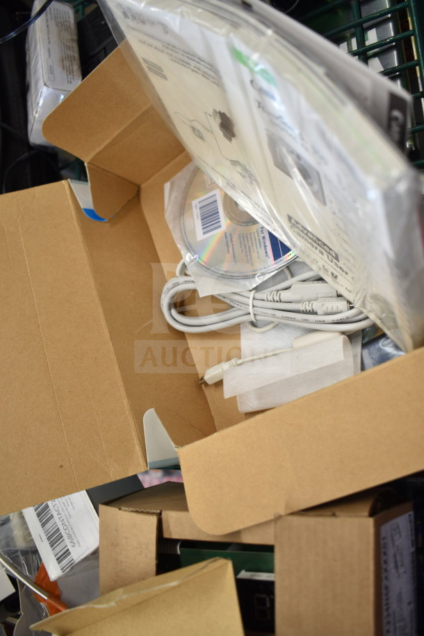 Box of assorted electronics, includes Canon digital camera, JVC recorder, cables, software CD, in varying conditions.