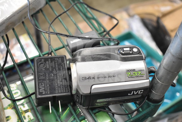 JVC camcorder with 34x optical zoom and 30GB storage, includes charger. Visible wear on body. Optical and record mode labels.