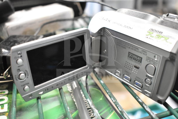 JVC camcorder with 34x optical zoom, 30GB storage, open LCD screen showing buttons and features, in used condition.