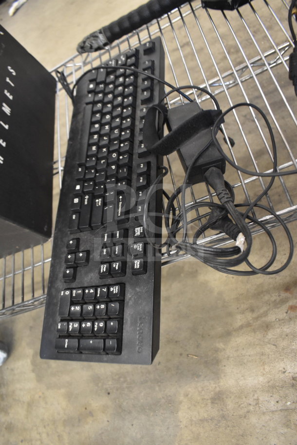 Lenovo keyboard on metal shelf, visible wear, tangled cables. Part of auction set with ProBreeze dehumidifier and ThinkCentre.